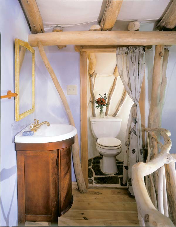 In the upstairs bathroom, floors are local rock and wood milled from trees on the farm.